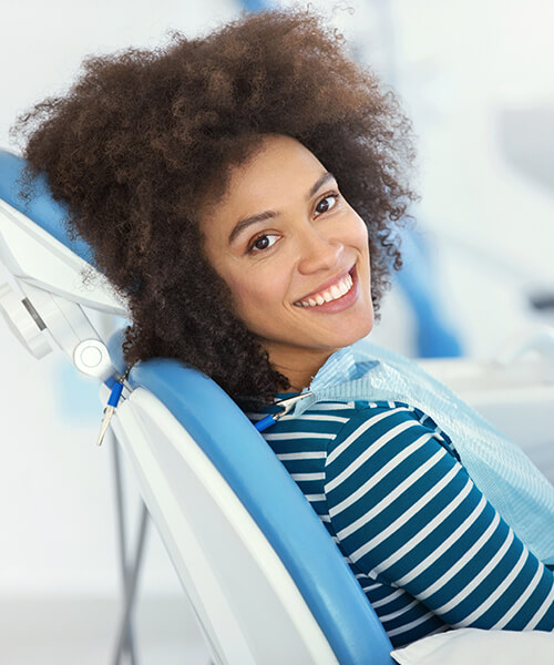 A woman in the dentist's chair waiting for her dental treatment